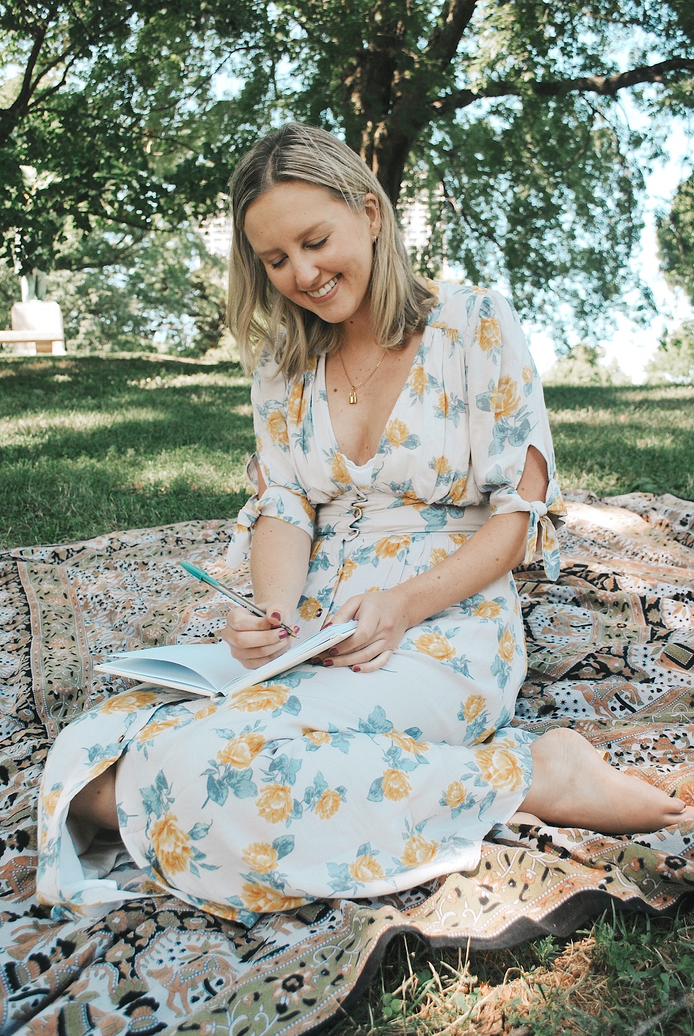 Young woman journaling in a park