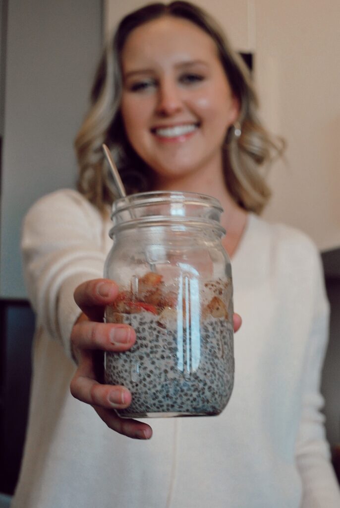 Mason jar full of chia seed pudding with a warm cinnamon apple topping
